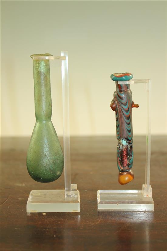 Two Roman glass unguentarium, c. 2nd century A.D., 10.5 and 12cm